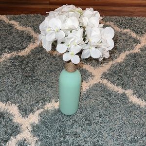 Green vase with white hydrangea